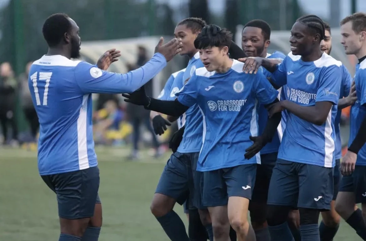 Players celebrating together during a football match