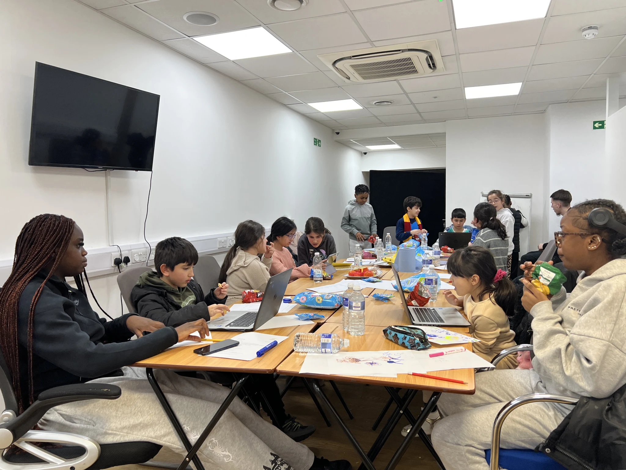 Students learning together around a classroom table