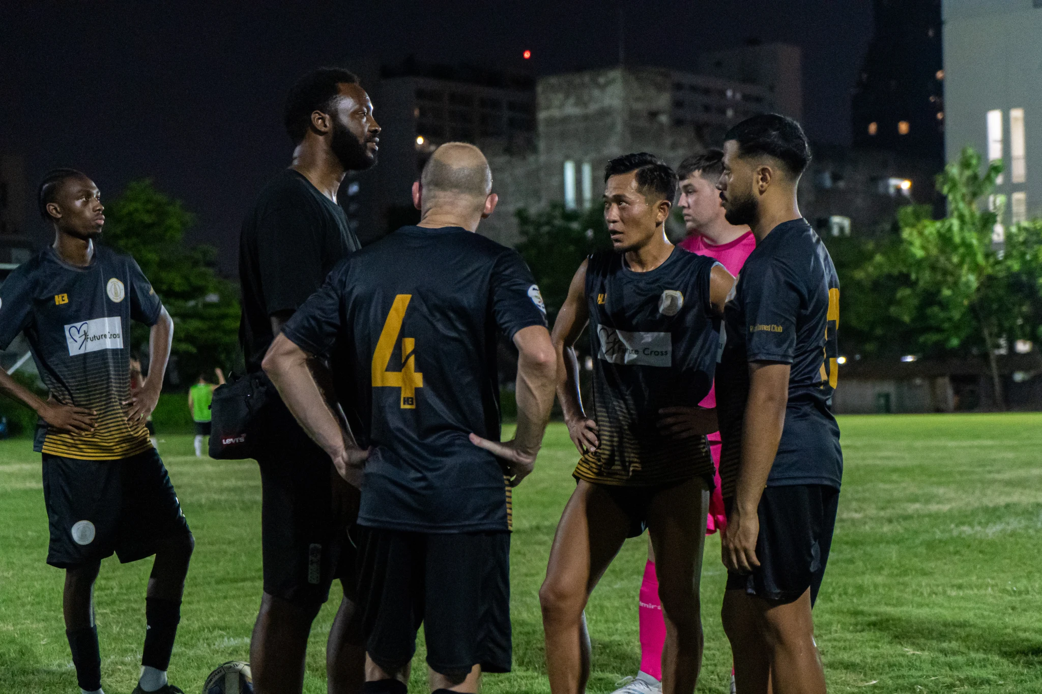 Players and coaches talking beside the pitch