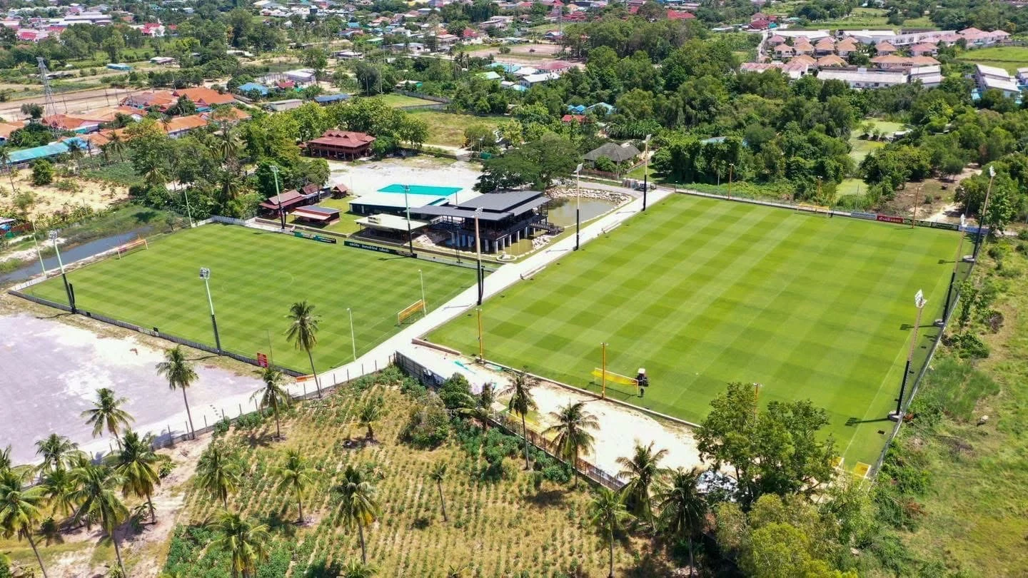 Aerial view of football grounds in a green surrounding area